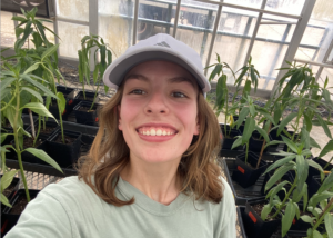 Anna Shattuck standing in a greenhouse